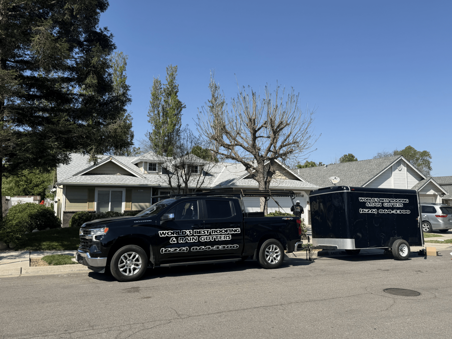 World's Best Roofing truck and trailer at a completed job site